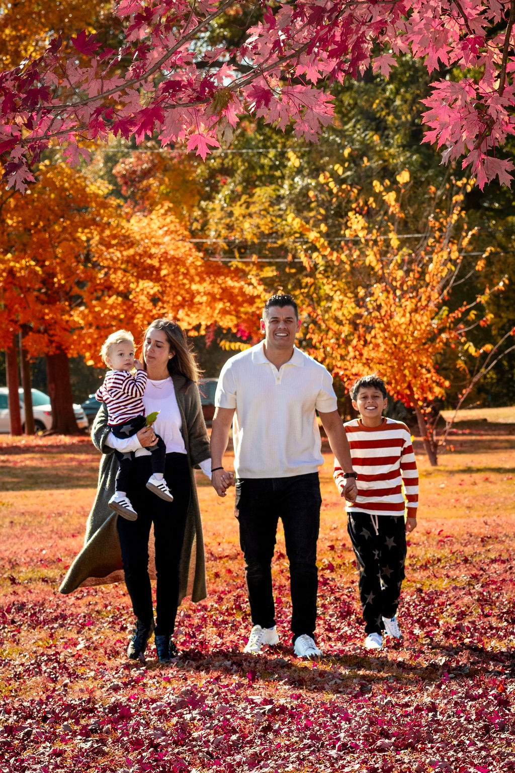 Couple walking through a golden-hour field