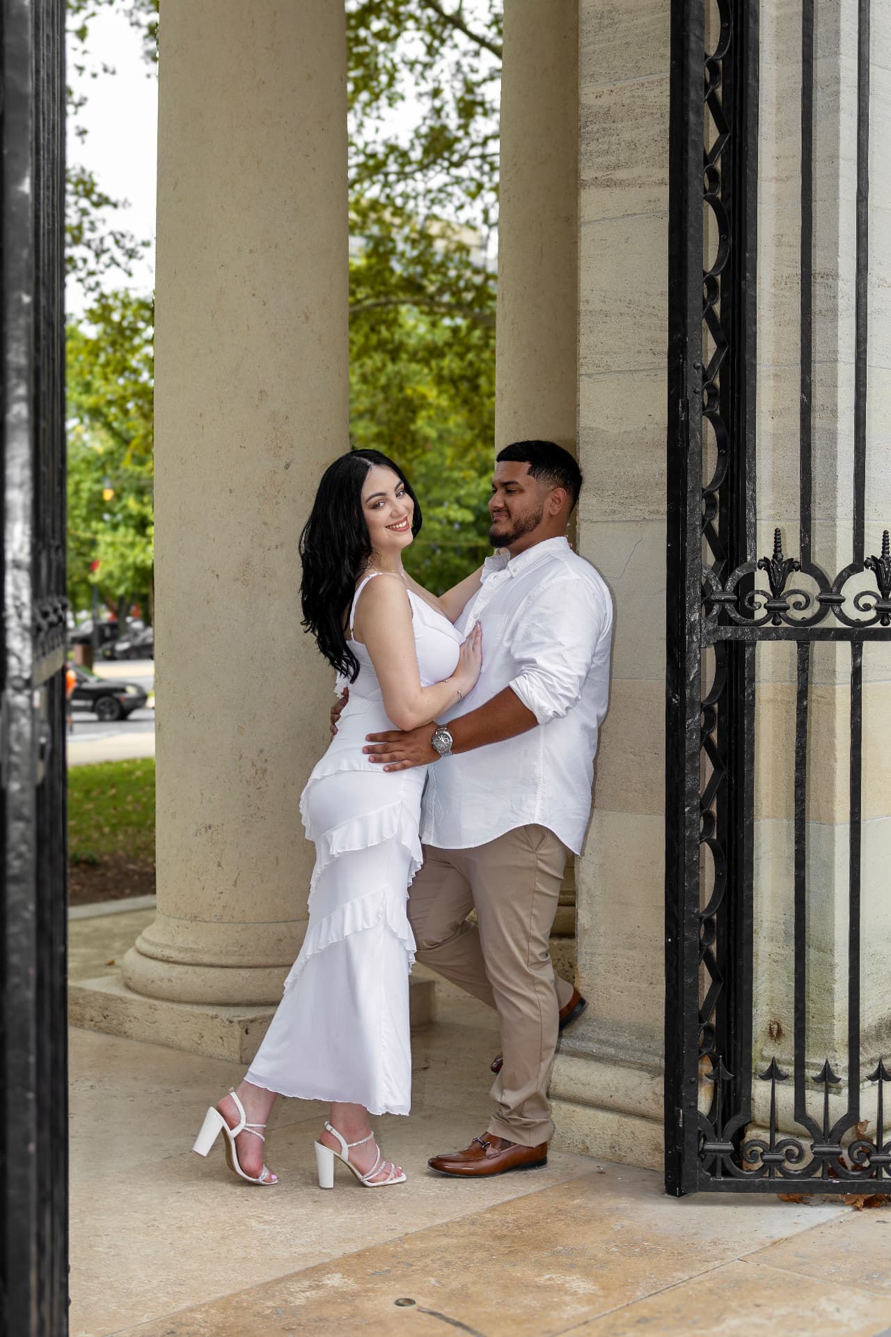 Angel & Val embracing between stone columns