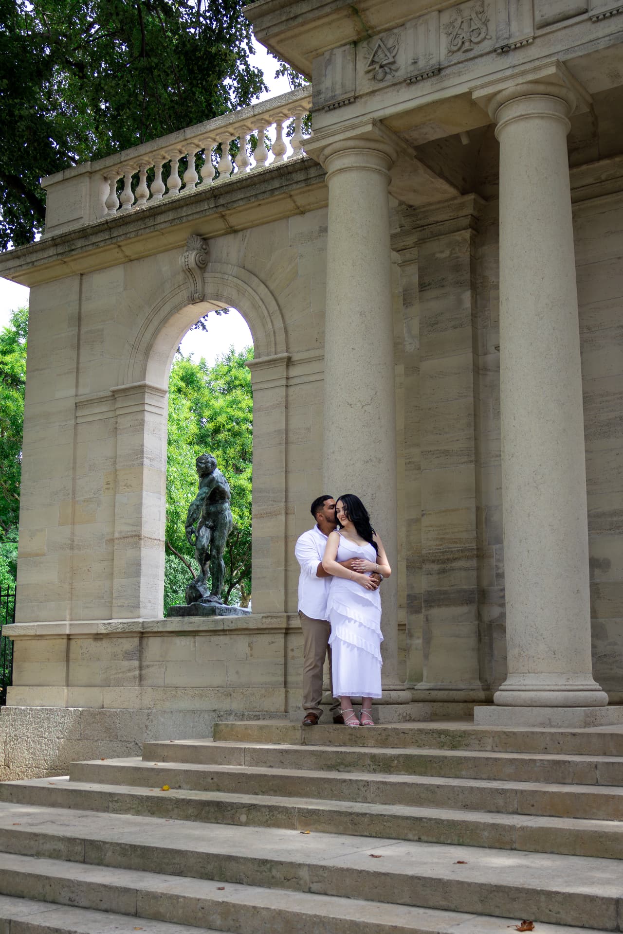 Angel & Val on the steps of a stone pavilion